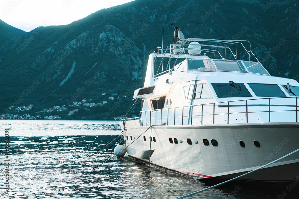 Luxury boats docked near waterfront buildings. Luxury boats docked near waterfront buildings.