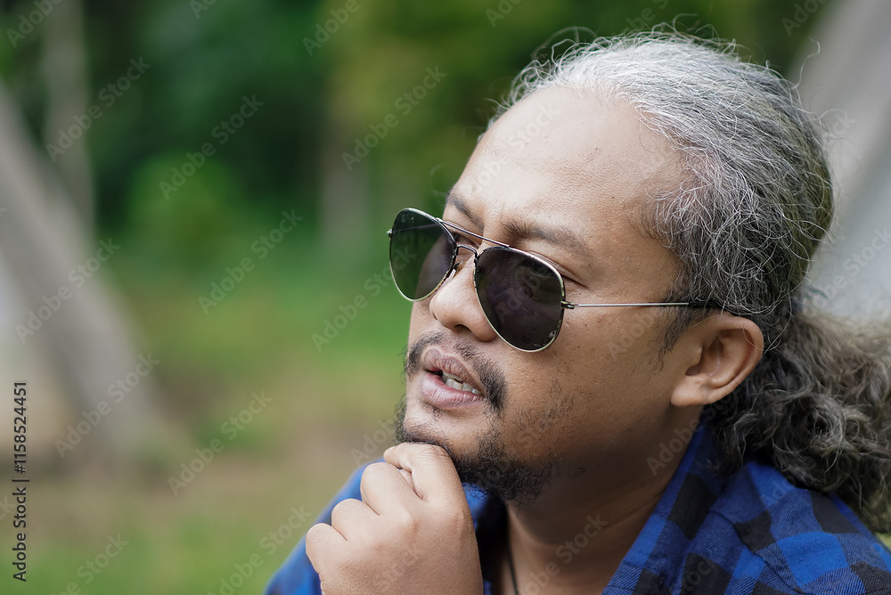 Curly-haired man goes camping alone in forest cabin, concept of travel. Curly-haired man goes camping alone in forest cabin, concept of travel.