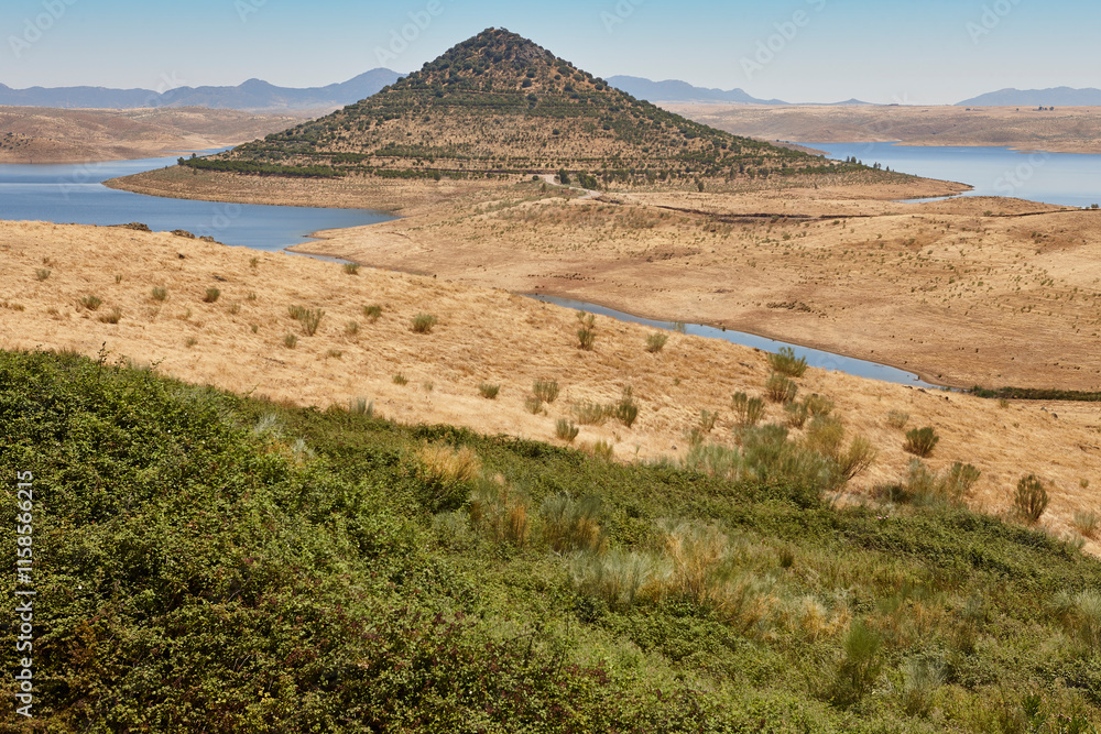Picturesque hill pyramidal shape huge roundabout and road. Extremadura, Spain
