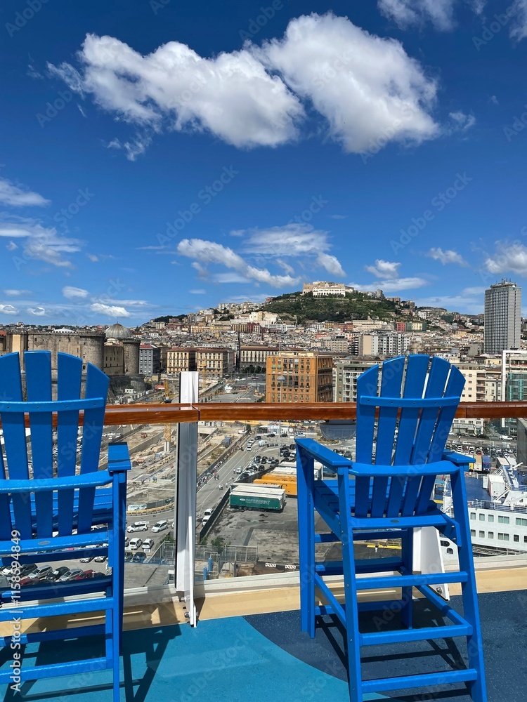 Obraz premium View with blue, high chairs from deck at a Mediterranean port