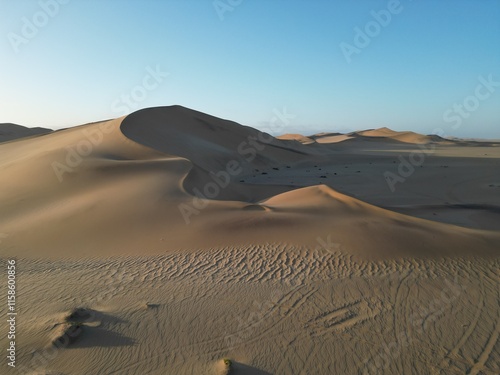Dune and blue sky captured with a drone during sunset golden hour in the desert