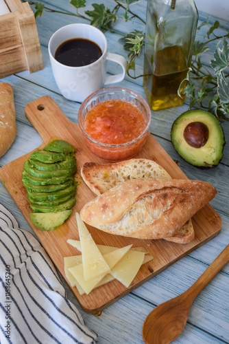 mediterranean breakfast of toast with tomato and avocado, cheese and coffee.