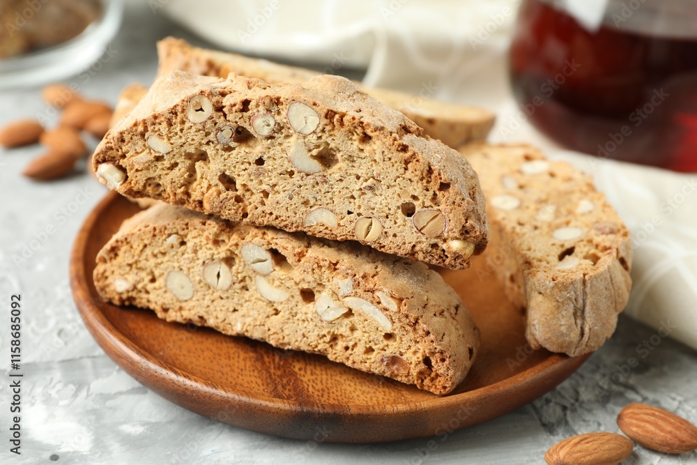 Traditional Italian almond biscuits (Cantucci) on grey textured table, closeup