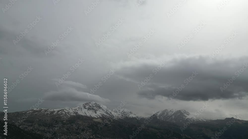 Majestic mountain range under cloudy sky during late afternoon Majestic mountain range under cloudy sky during late afternoon
