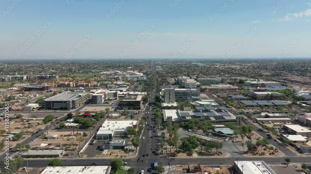 Busy Traffic scene on Main Street in Chandler, Arizona. Sunny day with clear blue sky in Arizona. Downtown shot with office buildings and homes. Aerial wide shot dolly. Busy Traffic scene on Main Street in Chandler, Arizona. Sunny day with clear blue sky in Arizona. Downtown shot with office buildings and homes. Aerial wide shot dolly.