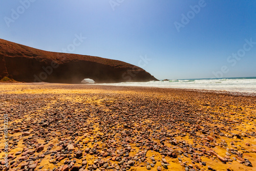 A beautiful beach and natural red arch on the Atlantic Ocean coast. Legzira Beach (or Lagzira, or Gzira). Sidi Ifni, Morocco, Africa photo