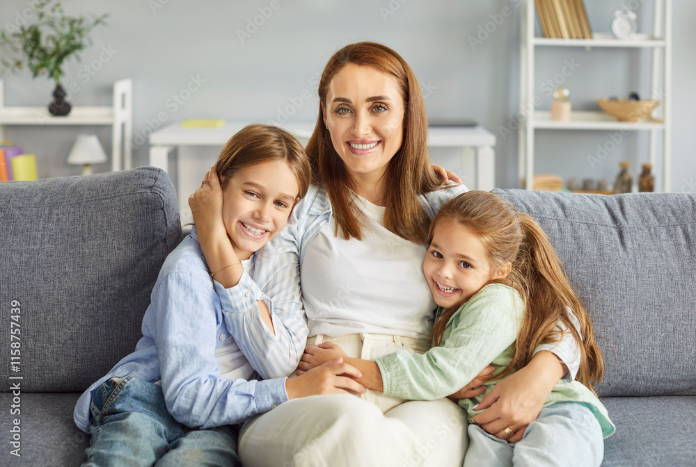 Portrait of a happy mother with kids, siblings sitting on a comfortable couch at home living room. Affection, love, and strong relationships between parent and children in a cozy domestic environment. Portrait of a happy mother with kids, siblings sitting on a comfortable couch at home living room. Affection, love, and strong relationships between parent and children in a cozy domestic environment.