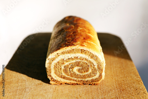  Traditional Hungarian Homemade Christmas Beigli or Bejgli Cake on Wooden Board. Holiday Background photo