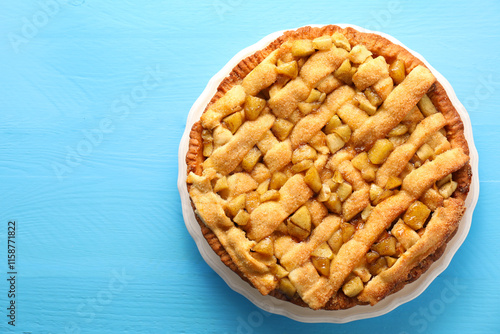 Tasty homemade apple pie on light blue wooden table, top view. Space for text