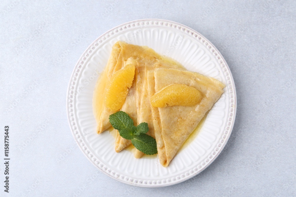 Delicious Crepes Suzette on light table, top view Delicious Crepes Suzette on light table, top view
