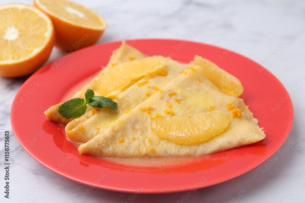 Plate with tasty crepes Suzette on white marble table, closeup Plate with tasty crepes Suzette on white marble table, closeup