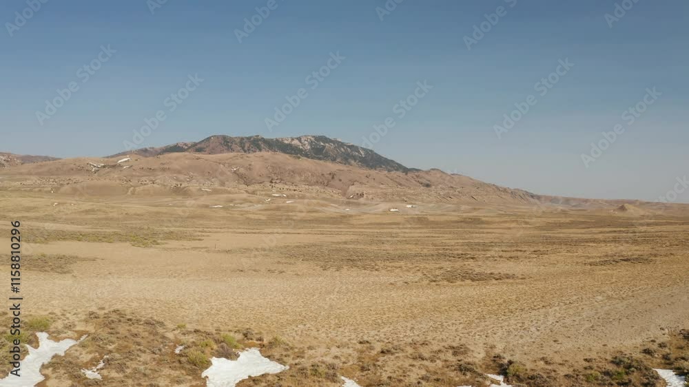 Drone Shot of Desolate road in the Wyoming desert. This shot tracks forward. Drone Shot of Desolate road in the Wyoming desert. This shot tracks forward.