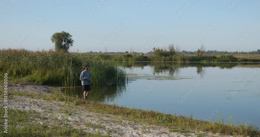 Young Caucasian Man Runs on Countryside Nature. Slow motion 60fps 4K 10-bit Young Caucasian Man Runs on Countryside Nature. Slow motion 60fps 4K 10-bit
