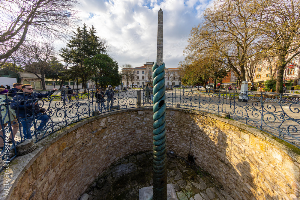 Serpentine Column (Turkish: Yilanlı Sutun) behind Ibrahim Pasha Palace at Sultanahmet Hippodrome Square on in Istanbul, Turkey.