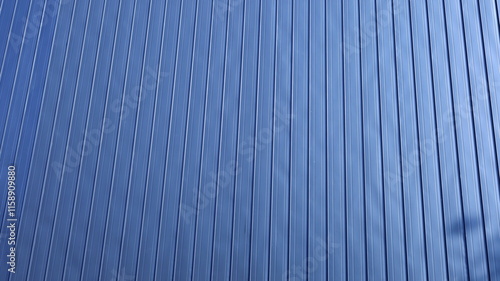 Corrugated metal sheet wall. Background of black corrugated steel sheets with vertical corrugations as wall of modern building with copy space with selective focus. photo