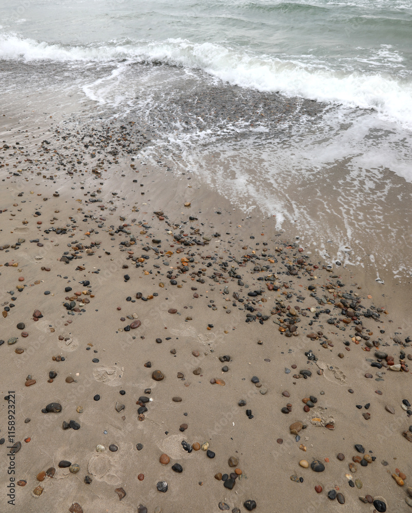 Sea shore with rocks being buried by sand and wind Sea shore with rocks being buried by sand and wind