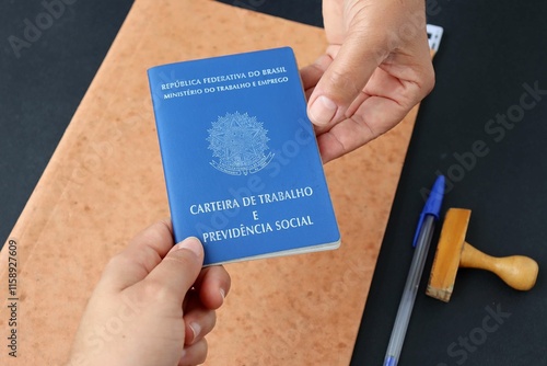 Signing the Brazilian work card. Translation: Federative Republic of Brazil, Ministry of Labor.| Brazilian Work Card (Carteira de Trabalho). Formal job concept. photo