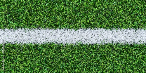 Close up of detailed green soccer field grass texture featuring a white line in the center, showcasing the vibrant lawn and artificial surface qualities of the soccer field. photo