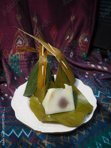 Coconut Sticky Rice Hand Holding Thai Dessert in Banana Leaf