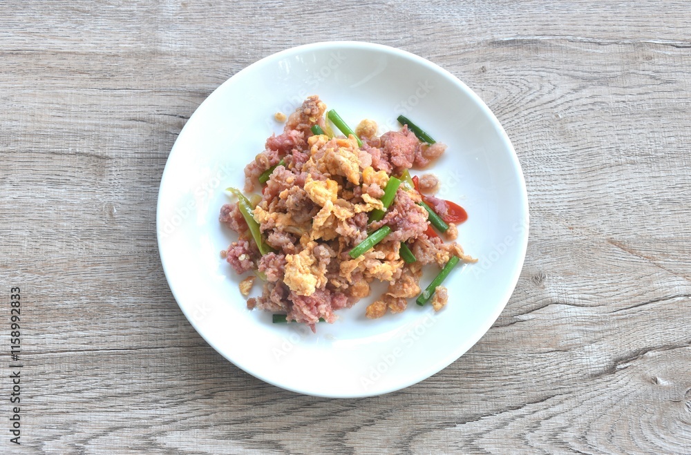 spicy fried chop fermenting sour pork with egg and spring onion on plate