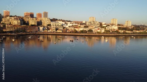 paisagem do Porto e de Matosinhos, onde o Rio Douro encontra o Oceano Atlântico. A cena apresenta as areias douradas da praia de Matosinhos, ladeadas pelas águas azul-escuras do oceano.  photo