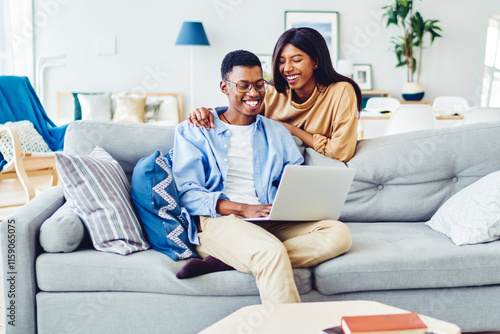 Happy black couple using laptop together photo