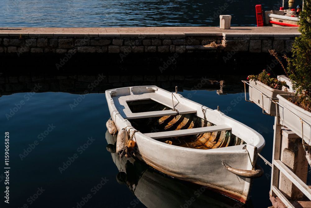 small boats tightened at berth on quee in Perast , Montenegro, tranquility moment small boats tightened at berth on quee in Perast , Montenegro, tranquility moment