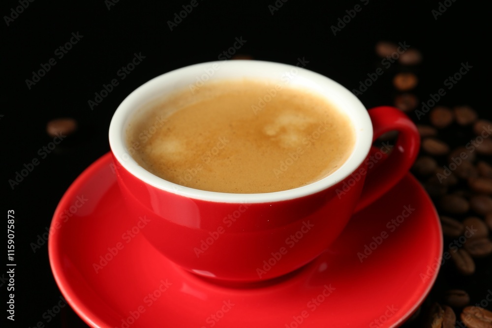 Red cup with coffee and roasted beans on black background, closeup Red cup with coffee and roasted beans on black background, closeup
