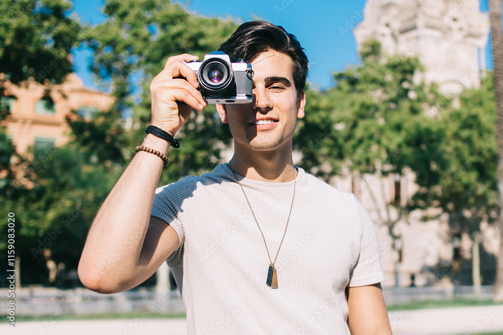 Happy caucasian male traveler holding camera focusing while taking picture of urban setting in city, cheerful man photographer amateur enjoying spending free time on hobby during trip vacations Happy caucasian male traveler holding camera focusing while taking picture of urban setting in city, cheerful man photographer amateur enjoying spending free time on hobby during trip vacations