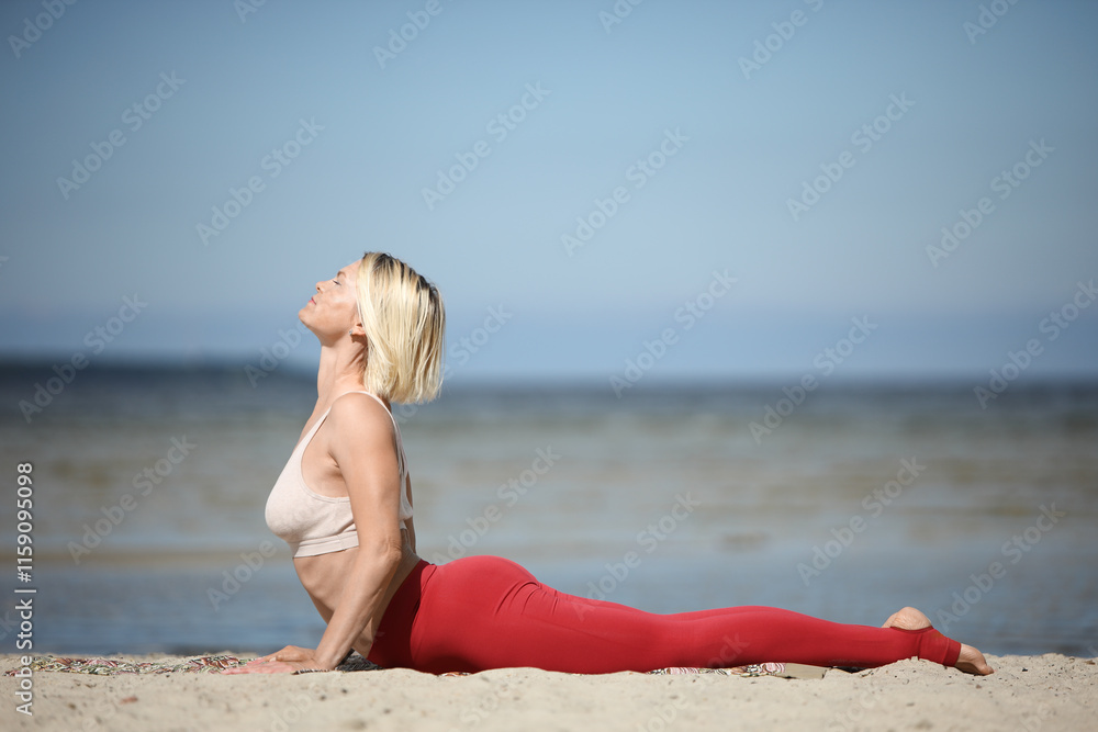 Young woman practicing yoga on the beach Young woman practicing yoga on the beach