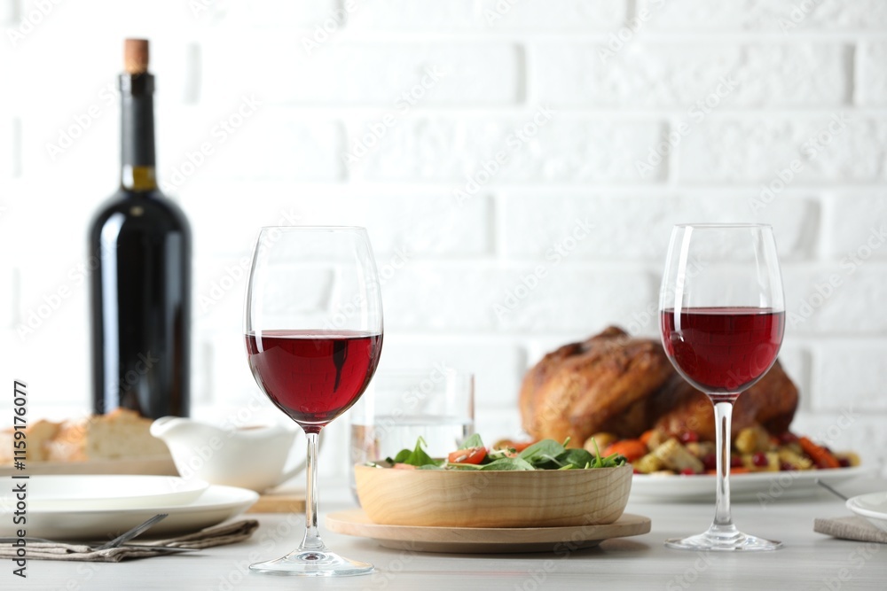 Red wine and delicious dinner served on light table Red wine and delicious dinner served on light table