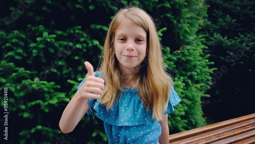 Obraz na plátně 9 year old girl showing thumbs up.