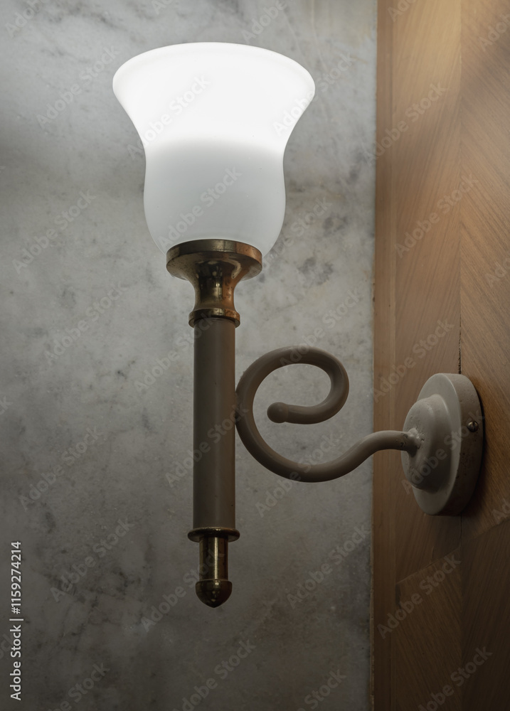 Old vintage lamp illuminated on the wooden wall (uplighter). Classic metal wall lamp, Lamp create a warm and elegant ambiance, perfect for vintage-themed, use it as your Wallpaper, Poster and Space.