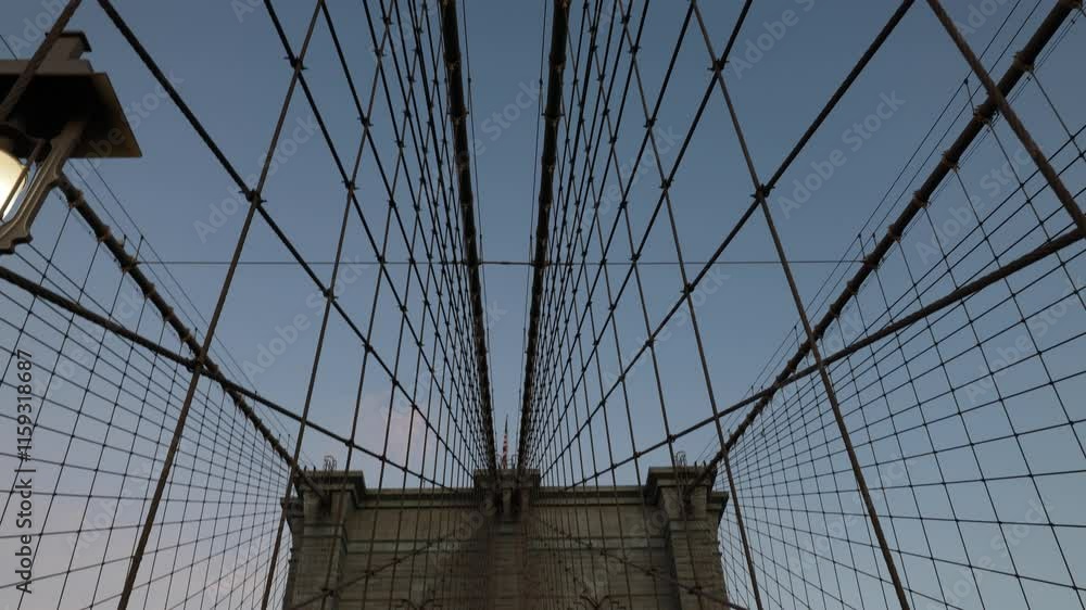 panning up at the brooklyn bridge at sunrise (beautiful suspension overpass pedestrian walkway between manhattan and borough new york city) nyc landmark travel tourism destination panning up at the brooklyn bridge at sunrise (beautiful suspension overpass pedestrian walkway between manhattan and borough new york city) nyc landmark travel tourism destination