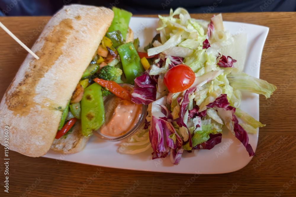 Ciabatta with baked vegetables and salad of fresh vegetables Ciabatta with baked vegetables and salad of fresh vegetables