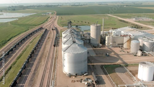 Aerial flyover a factory producing ethanol and adjoining railroad yard in rural eastern South Dakota.