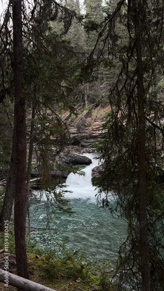 A serene forest scene with a small, rushing waterfall surrounded by dense trees and clear, turquoise water. A tranquil escape into nature's beauty. A serene forest scene with a small, rushing waterfall surrounded by dense trees and clear, turquoise water. A tranquil escape into nature's beauty.