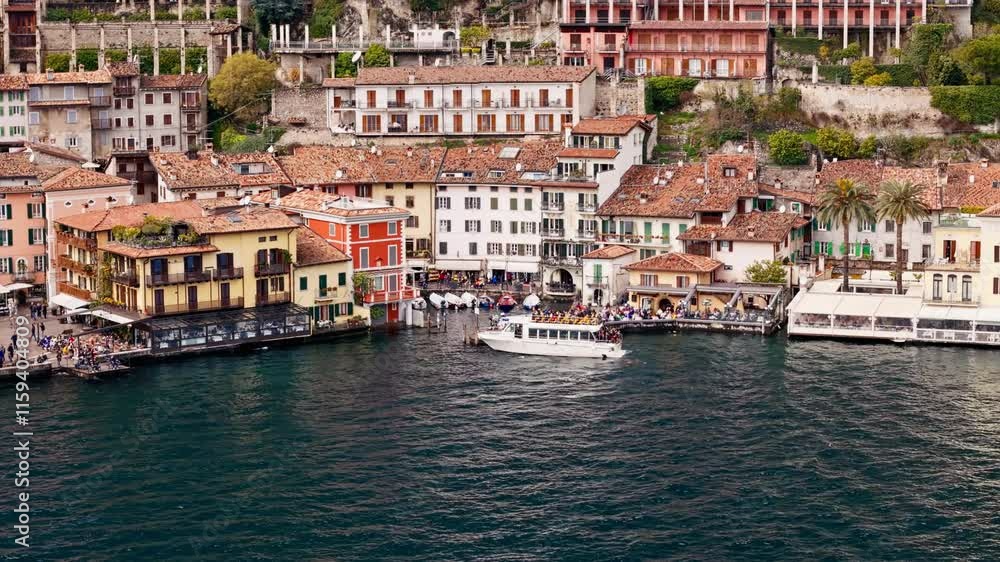 Passengers sailing boat arrive to Limone sul Garda on Lake Garda. Tourist and leisure transport on the Italian lake Passengers sailing boat arrive to Limone sul Garda on Lake Garda. Tourist and leisure transport on the Italian lake