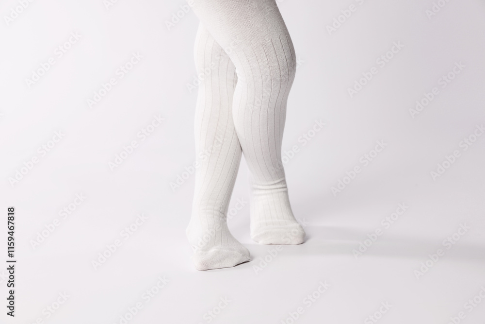 Child wearing tights on white background, closeup Child wearing tights on white background, closeup