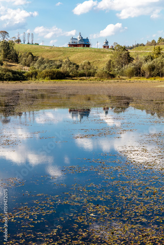 A lake with a house in the background photo