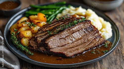 Sliced beef brisket with roasted potatoes, gravy, mashed potatoes, and green beans. photo