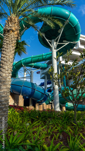 Water slides at Aquaventure Water Park on background of. The largest water theme park in Middle East, Dubai, United Arab Emirates. Vertical image photo