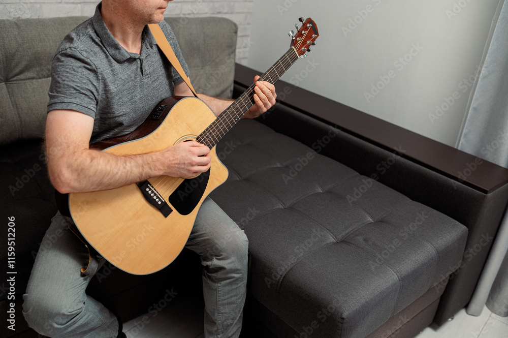 Obraz premium Guitarist on acoustic guitar playing melody in studio. Close up musician instrument