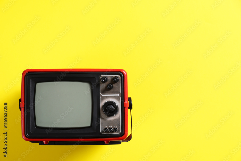 Retro tv set on yellow background, top view. Space for text Retro tv set on yellow background, top view. Space for text