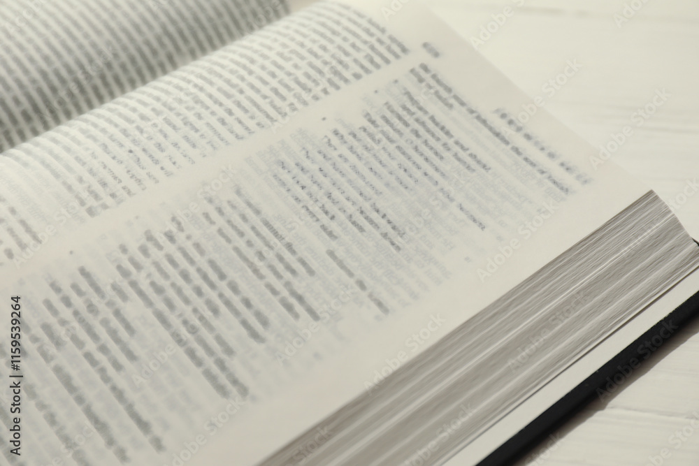 Open Holy Bible in English language on white table, closeup Open Holy Bible in English language on white table, closeup