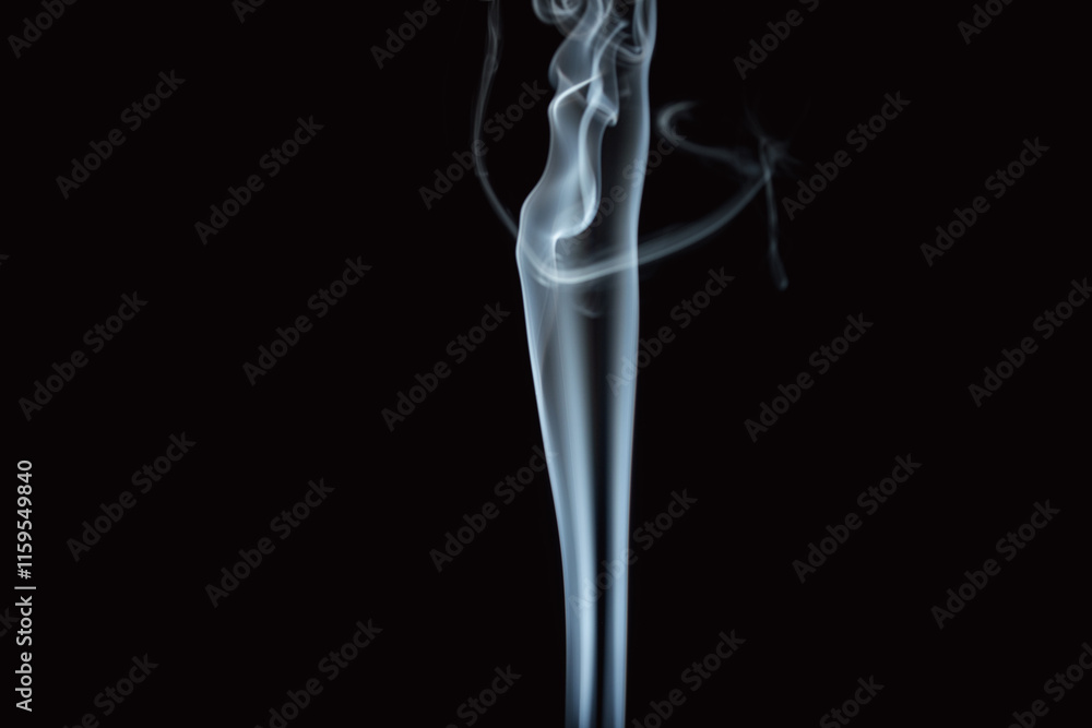 Graceful swirls of smoke rise elegantly against a dark background creating a mesmerizing display of movement Graceful swirls of smoke rise elegantly against a dark background creating a mesmerizing display of movement