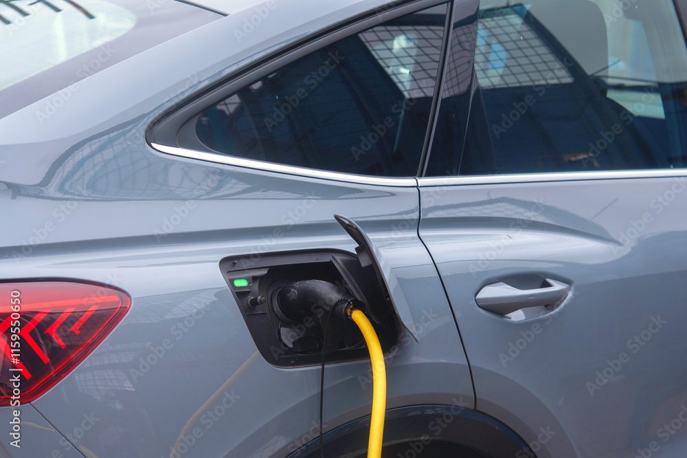 Fototapeta premium Electric vehicle charging at a modern station during daylight hours
