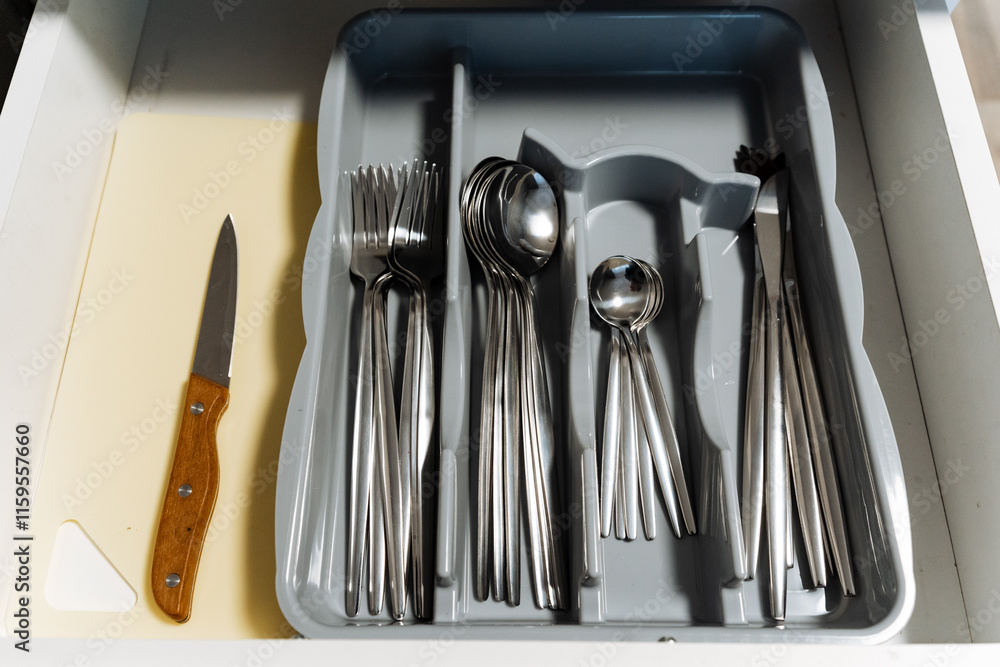 There is a drawer that is completely filled with an assortment of silverware, including various types of spoons, forks, and knives, a collection that is both functional and elegant for dining There is a drawer that is completely filled with an assortment of silverware, including various types of spoons, forks, and knives, a collection that is both functional and elegant for dining