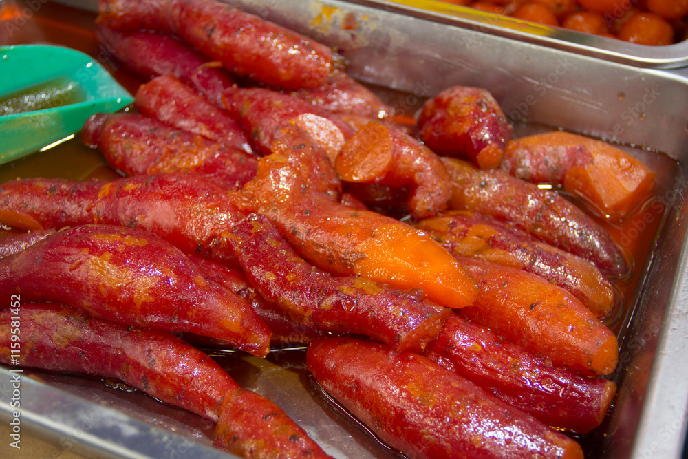 Traditional Mexican street food, candied sweet potatoes, close-up. Traditional Mexican street food, candied sweet potatoes, close-up.