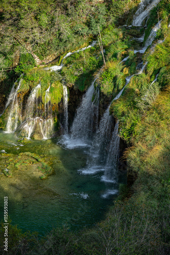 Beauty nature. Waterfall in the Plitvice Lakes in Croatia. The waterfalls in forest. Summer view of beautiful waterfalls and clear lake. Plitvice Lakes National Park, Croatia. Summer nature landscape.